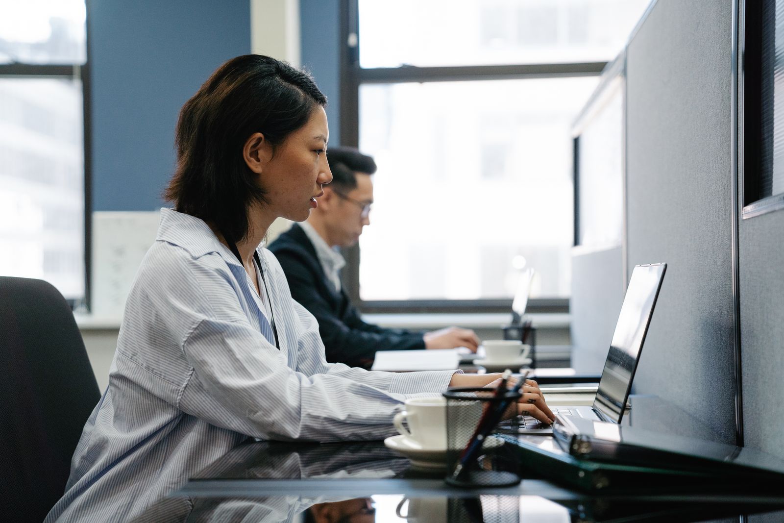 Laptops and monitors set up at desks in an office